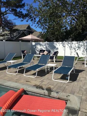 a view of a roof deck with table and chairs with wooden floor and fence