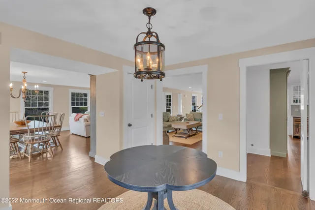 a living room with dining table and wooden floor