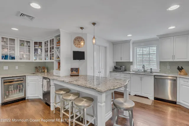 a kitchen with stainless steel appliances granite countertop a stove and a sink
