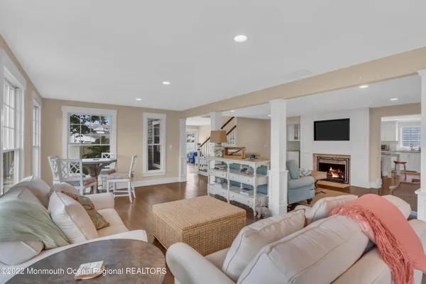 a living room with furniture and a view of kitchen