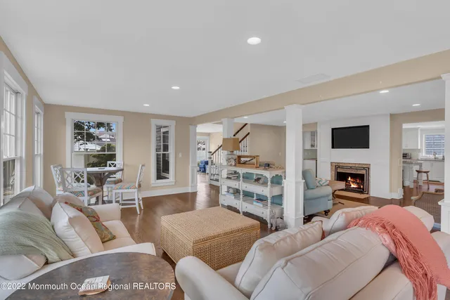 a living room with furniture and a view of kitchen