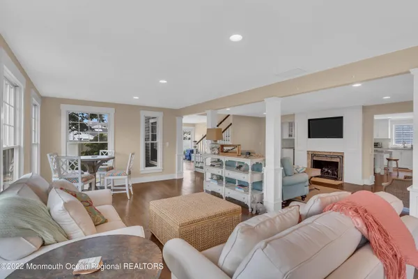 a living room with furniture and a view of kitchen
