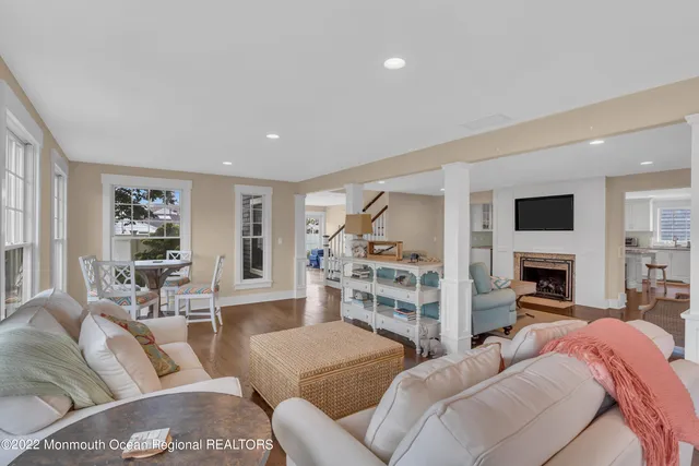 a living room with furniture and a view of kitchen