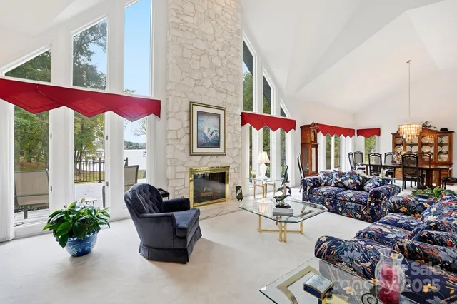 a living room with furniture and floor to ceiling windows