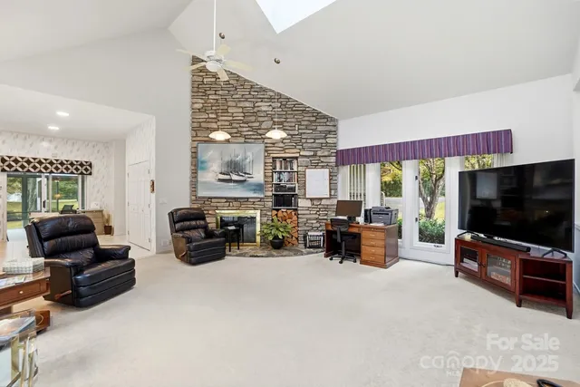 a living room with furniture fireplace and flat screen tv