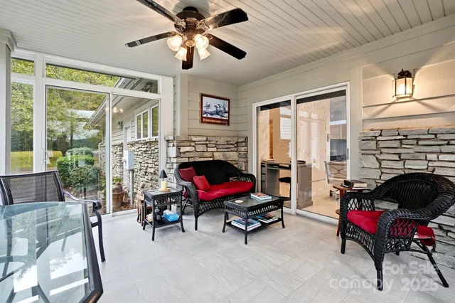 a view of a hallway with wooden floor and a glass door