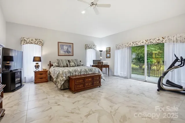 a spacious bathroom with a toilet sink double vanity and mirror
