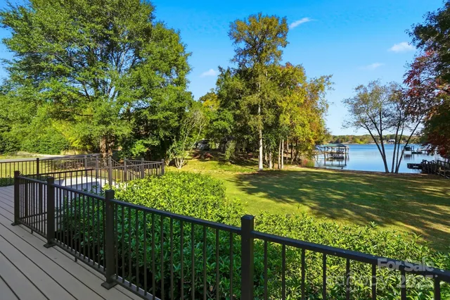 a view of a house with swimming pool and a yard