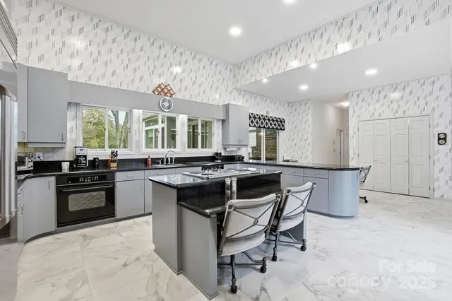 a kitchen with a sink stove and cabinets