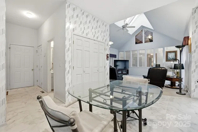a dining room with furniture and a window