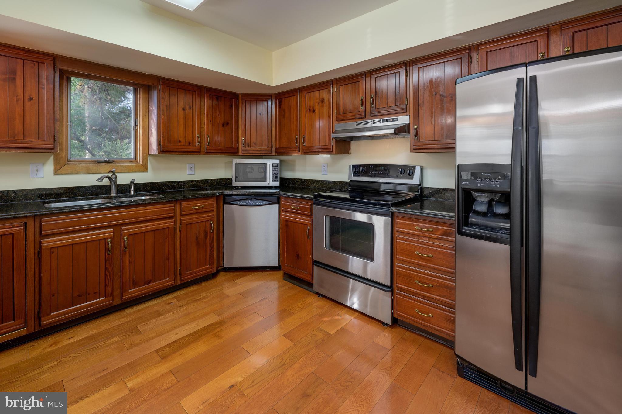 23 South Main Street, Unit 3 Medford, NJ 08055 - Photo 8 of 26 a kitchen with stainless steel appliances granite countertop a stove a sink and a refrigerator