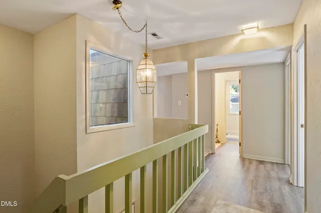 a spacious bedroom with two beds and a window