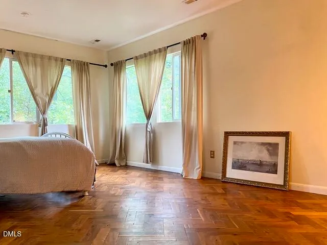 a spacious bedroom with a bed and a window