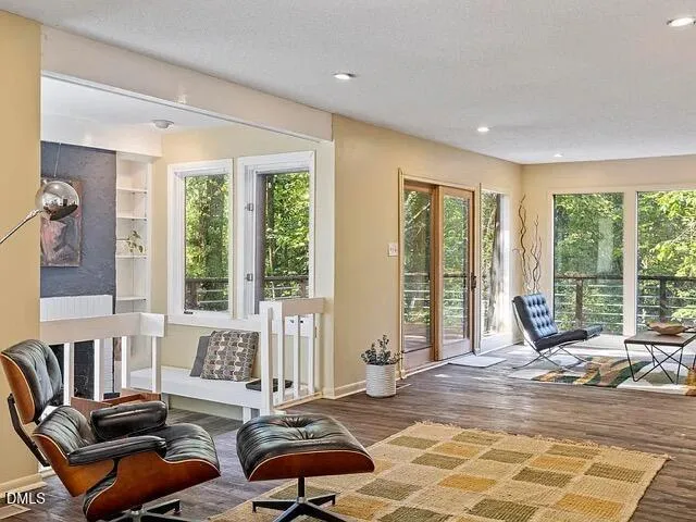 a living room with furniture rug and window