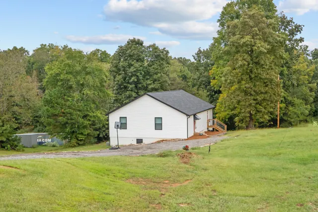 a view of a house with a backyard