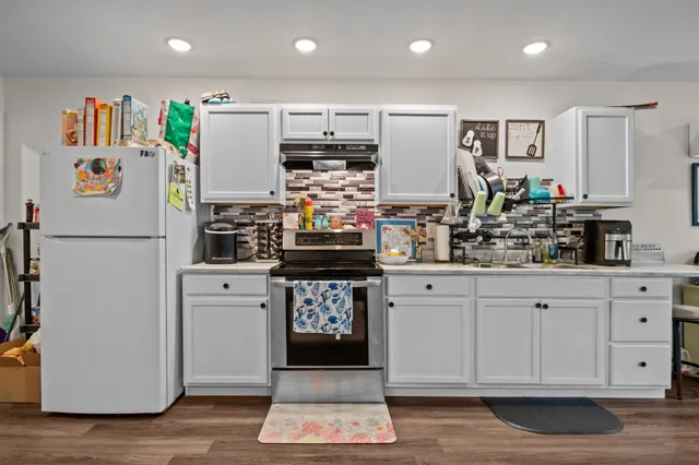 a kitchen with refrigerator and cabinets