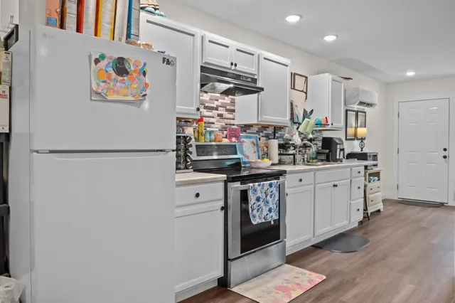a kitchen with refrigerator and window