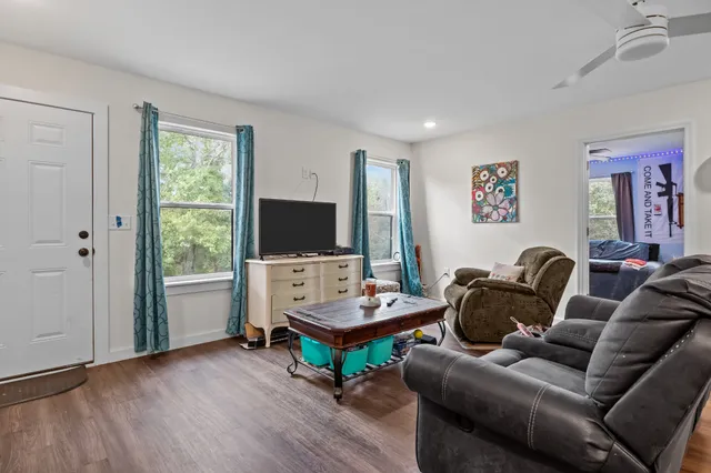 a living room with furniture and a flat screen tv