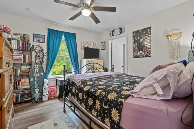 a bedroom with a bed and a window