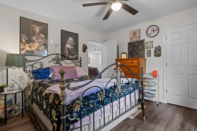 a bedroom with bed and a chandelier