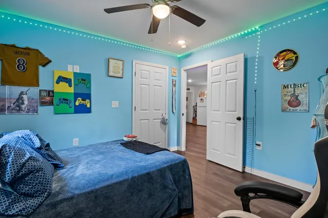 a bedroom with a bed and a chandelier