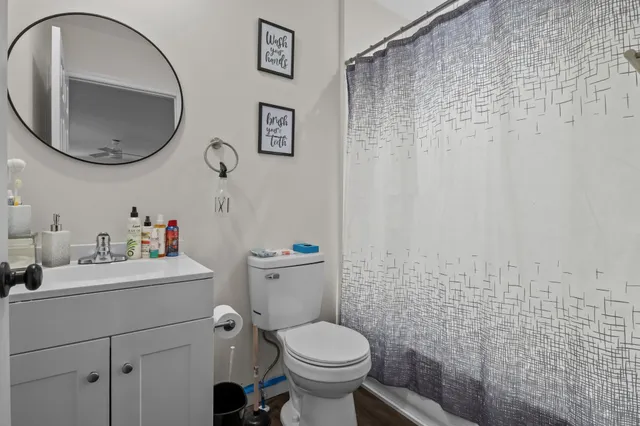 a bathroom with a sink a toilet and a mirror