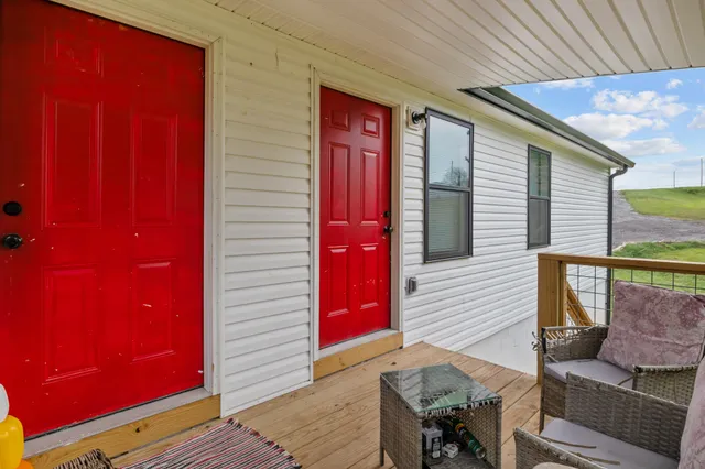 a view of a balcony with furniture and wooden floor
