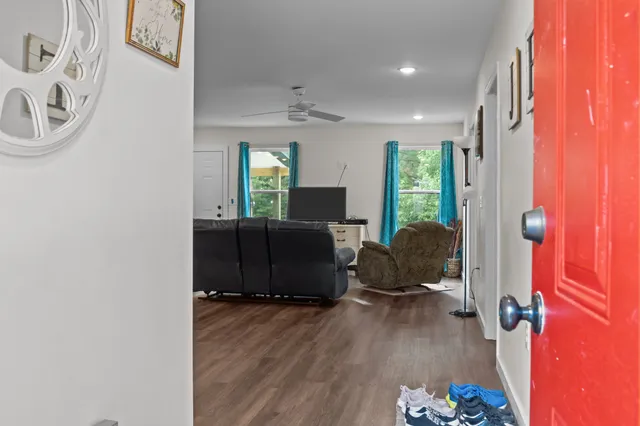 a living room with furniture and a wooden floor