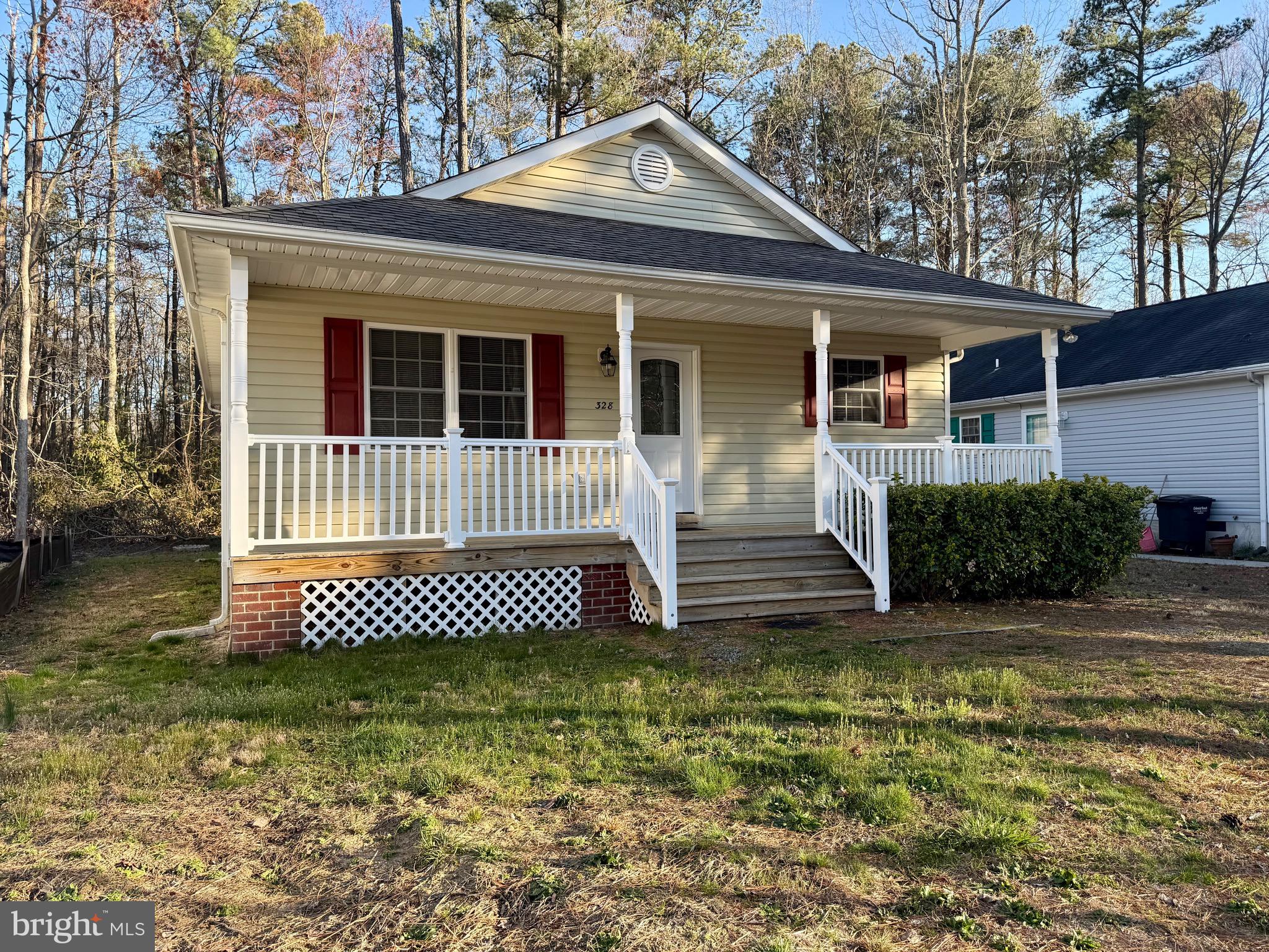 328 12th Street Colonial Beach, VA 22443 - Photo 2 of 19 a front view of a house with a garden