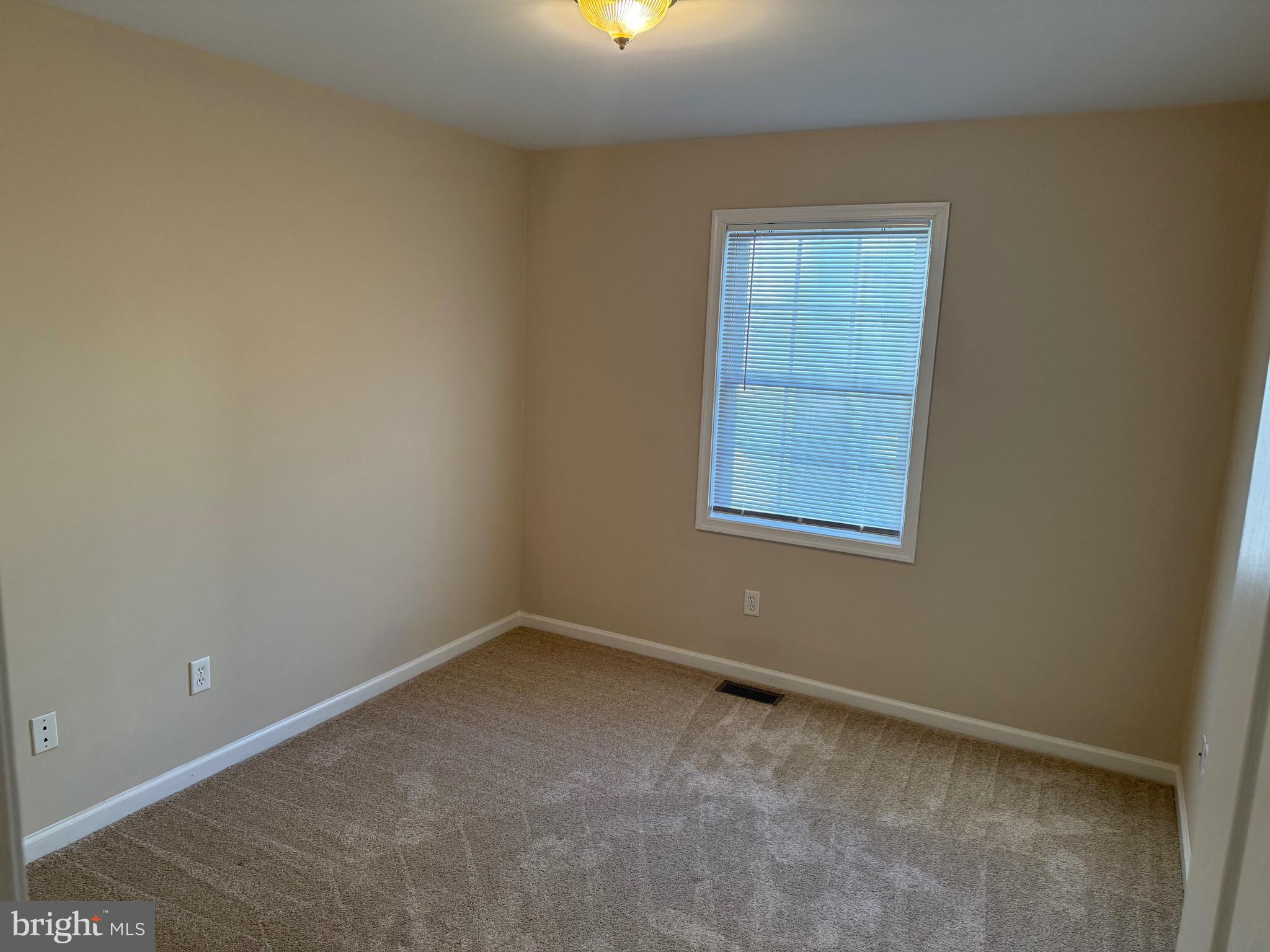 328 12th Street Colonial Beach, VA 22443 - Photo 7 of 19 an empty room with windows