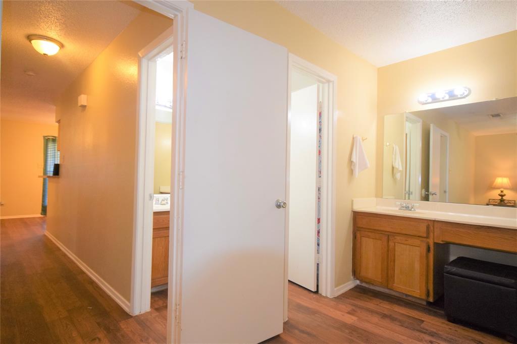 4909 Jamesway Road, Unit 203D Fort Worth, TX 76135 - Photo 11 of 17 a view of a bathroom with a sink and a mirror