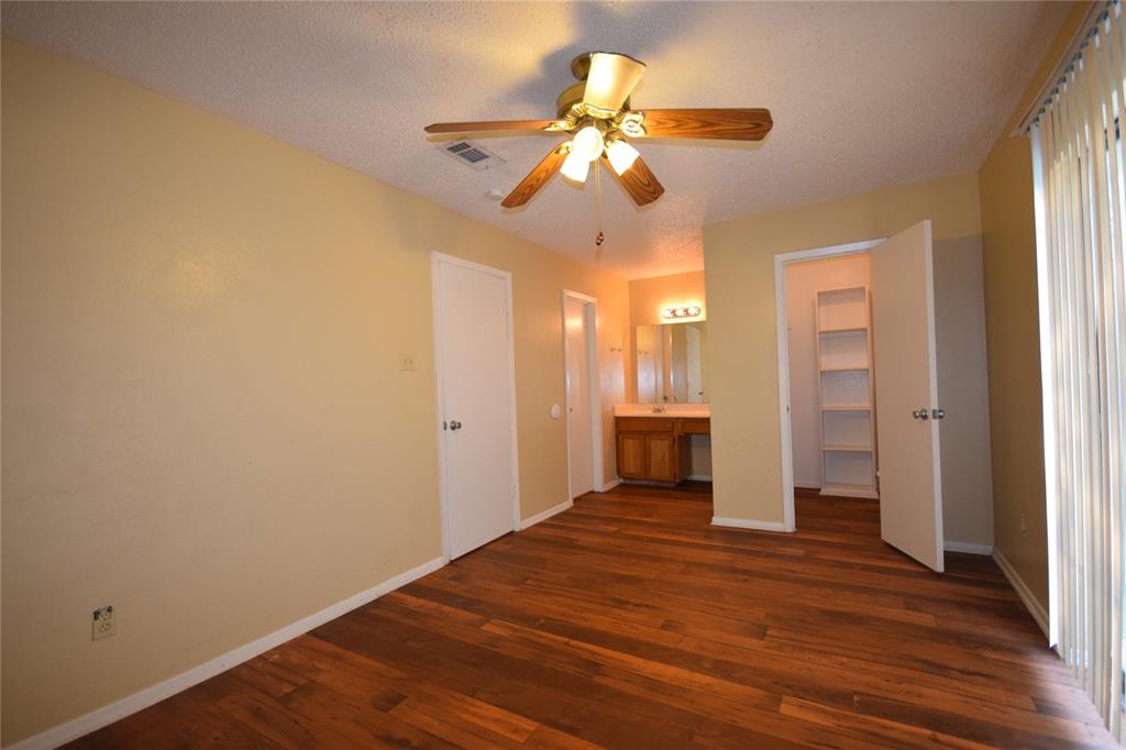 4909 Jamesway Road, Unit 203D Fort Worth, TX 76135 - Photo 13 of 17 wooden floor in an empty room with a window