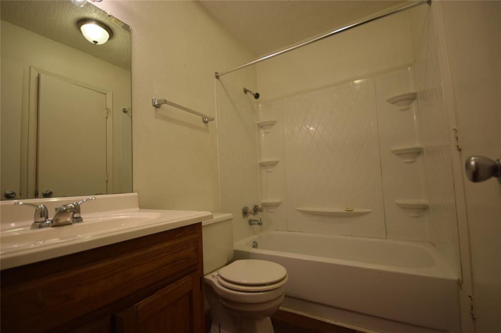 4909 Jamesway Road, Unit 203D Fort Worth, TX 76135 - Photo 14 of 17 a bathroom with a sink a toilet and shower