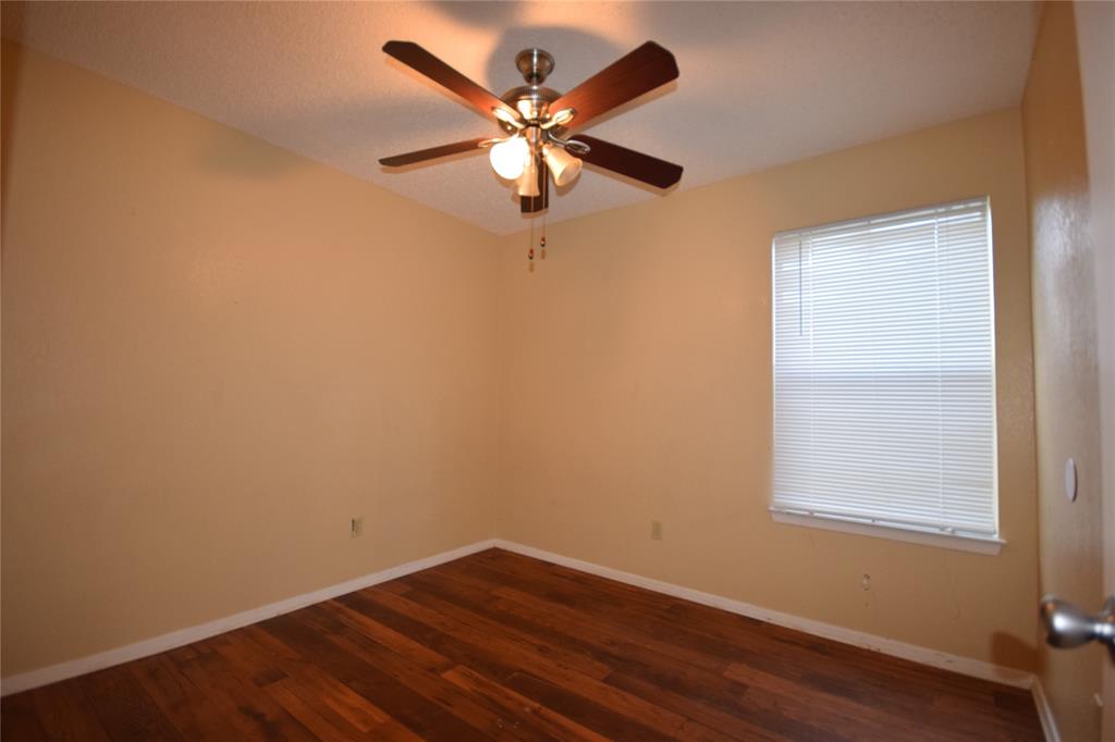 4909 Jamesway Road, Unit 203D Fort Worth, TX 76135 - Photo 15 of 17 an empty room with wooden floor and windows