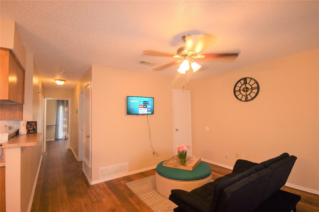 4909 Jamesway Road, Unit 203D Fort Worth, TX 76135 - Photo 4 of 17 a view of a livingroom with furniture and wooden floor