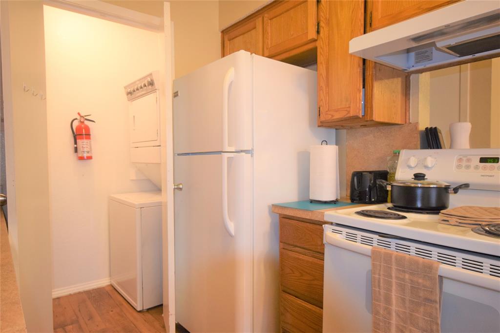 4909 Jamesway Road, Unit 203D Fort Worth, TX 76135 - Photo 5 of 17 a white refrigerator freezer sitting inside of a kitchen