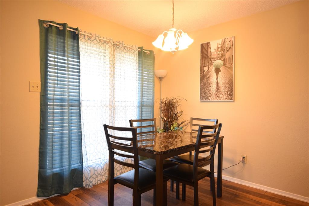 4909 Jamesway Road, Unit 203D Fort Worth, TX 76135 - Photo 8 of 17 a view of a dining room with furniture and chandelier