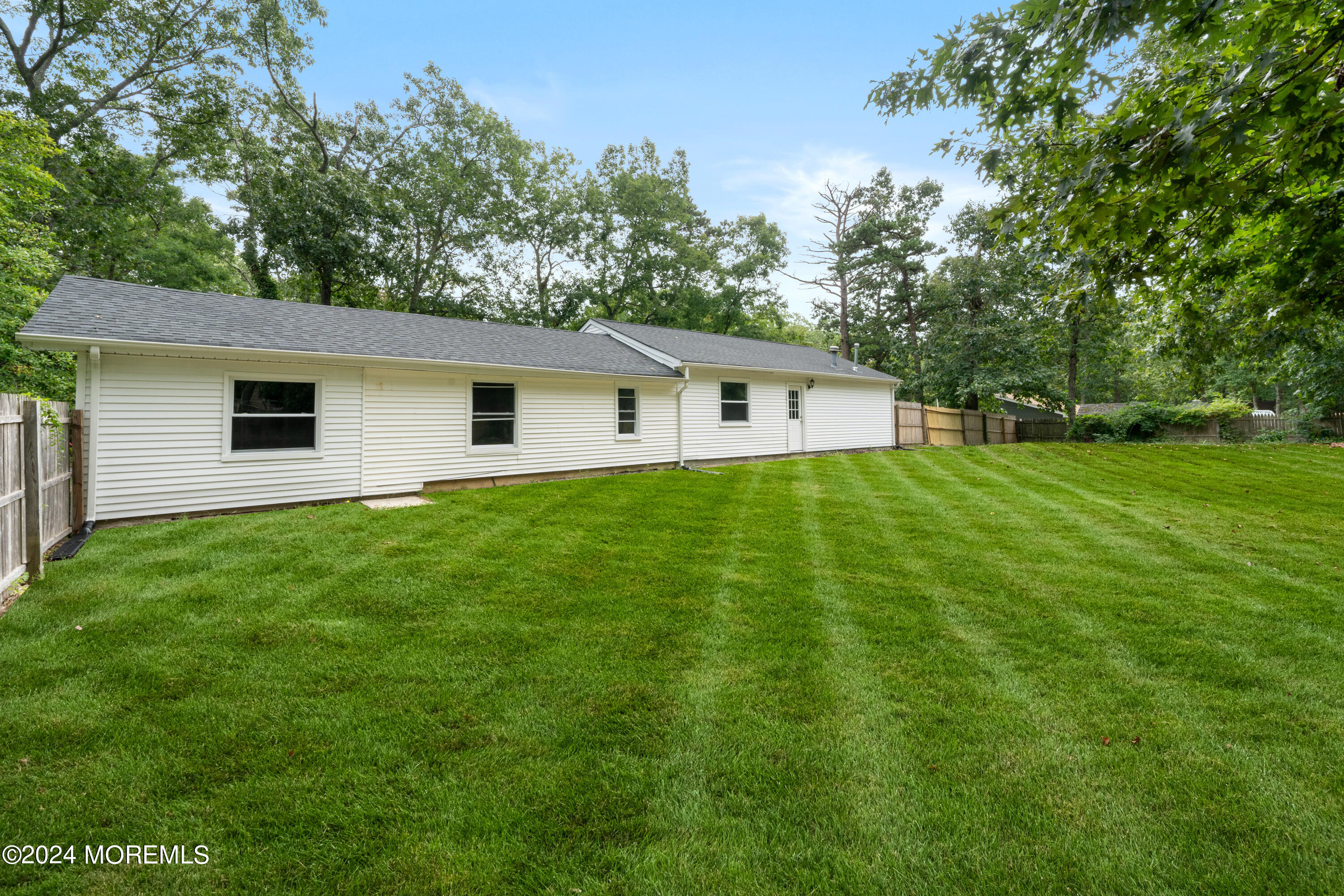 20 Willow Street Waretown, NJ 08758 - Photo 22 of 22 a white house that has a big yard with wooden fence