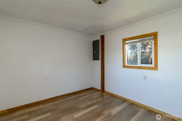 a view of an empty room with wooden floor
