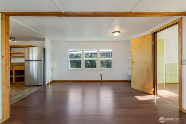 a view of a livingroom with wooden floor and a window