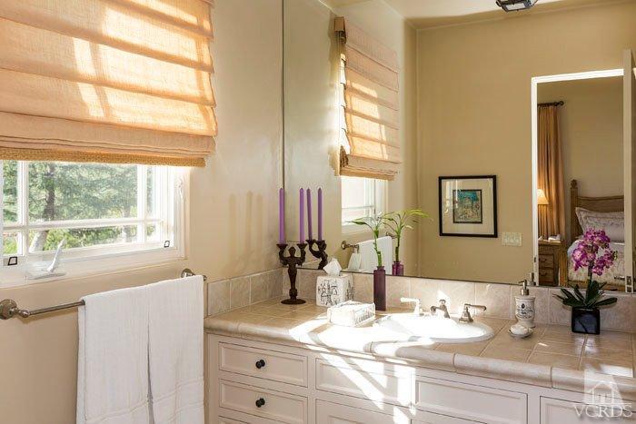 2300 White Stallion Road Thousand Oaks, CA 91361 - Photo 35 of 86 a bathroom with a granite countertop sink mirror and a window