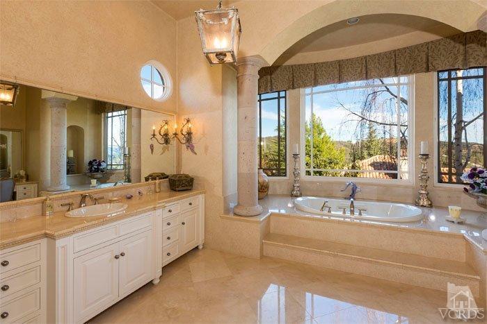2300 White Stallion Road Thousand Oaks, CA 91361 - Photo 43 of 86 a spacious bathroom with a double vanity sink a mirror and a bathtub next to a window