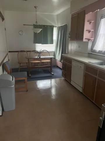 a kitchen with refrigerator and window