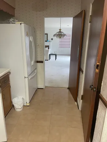 an empty room with fireplace and cabinets