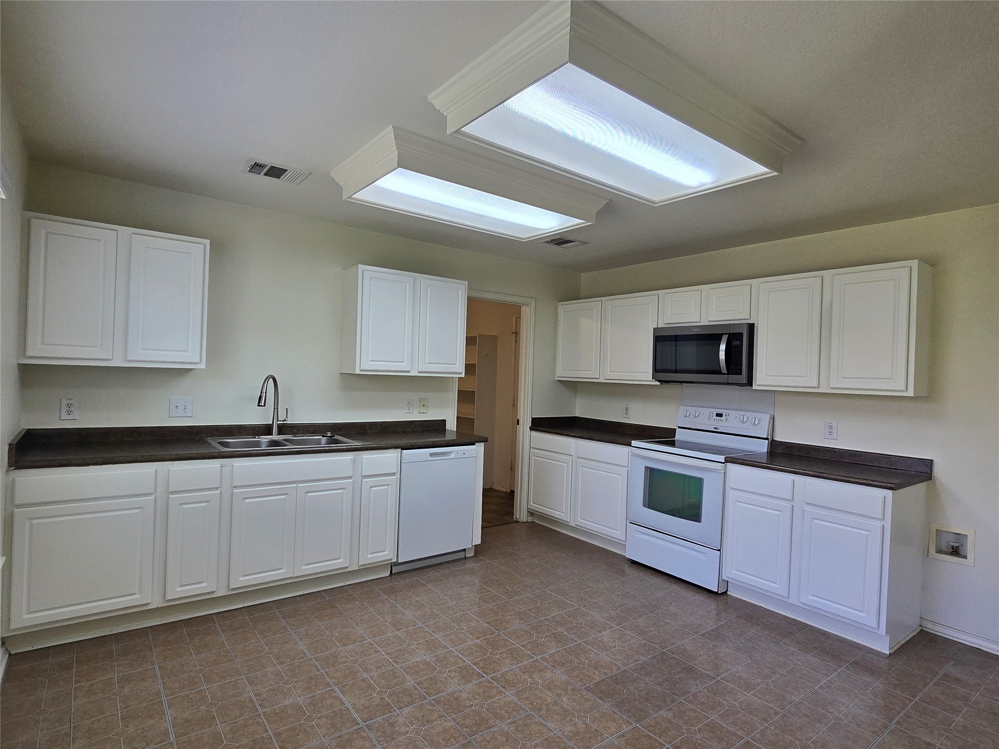 2021 Rim Rock Drive Leander, TX 78641 - Photo 12 of 14 Well-appointed kitchen features ample cabinetry, dual basin sink, and a full suite of appliances.