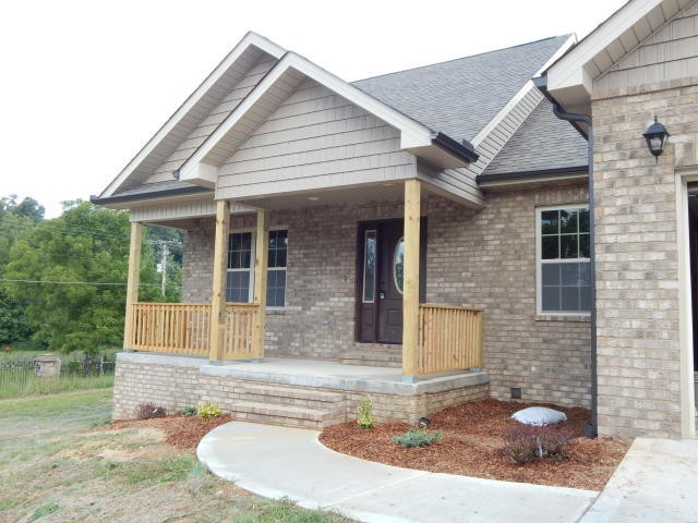 a view of a house with pool and porch