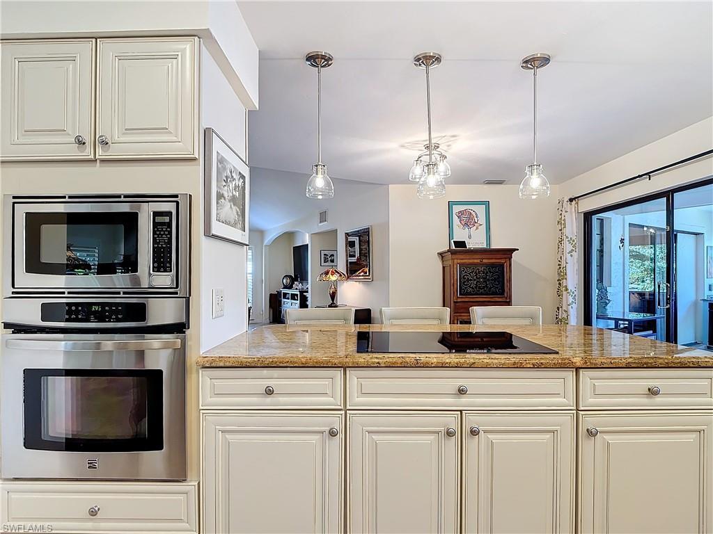 1659 Sandpiper Street, Unit E Naples, FL 34112 - Photo 20 of 50 a kitchen with stainless steel appliances granite countertop a stove a sink and a granite counter tops