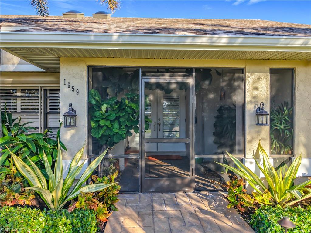 1659 Sandpiper Street, Unit E Naples, FL 34112 - Photo 2 of 50 a view of a building with garden