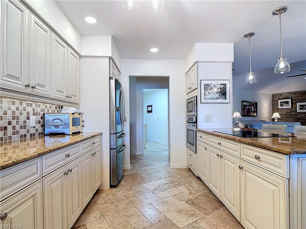 1659 Sandpiper Street, Unit E Naples, FL 34112 - Photo 23 of 50 a kitchen with granite countertop a sink and cabinets