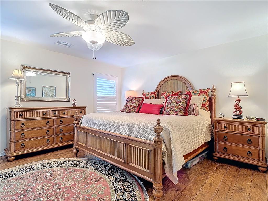 1659 Sandpiper Street, Unit E Naples, FL 34112 - Photo 24 of 50 a bedroom with a bed and a dresser